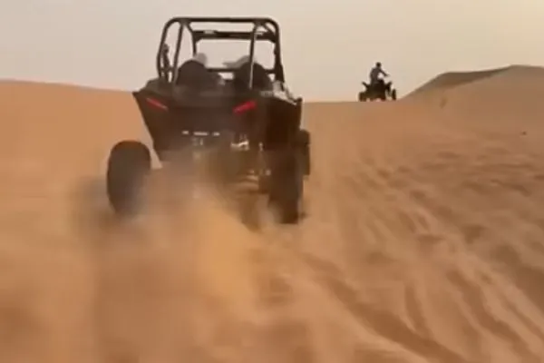 Family buggy tour on desert dunes