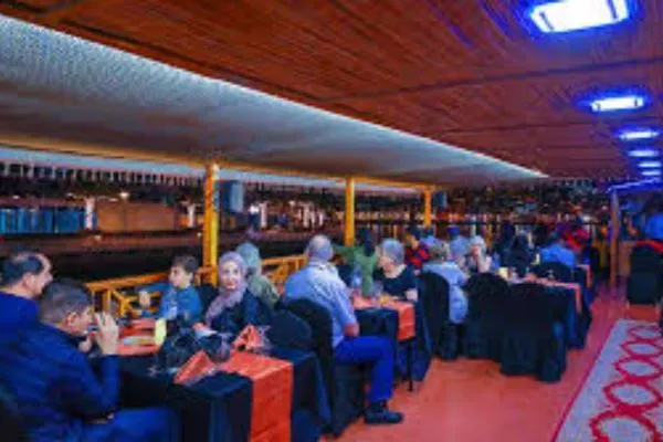 Dhow cruising past Dubai Marina towers at night